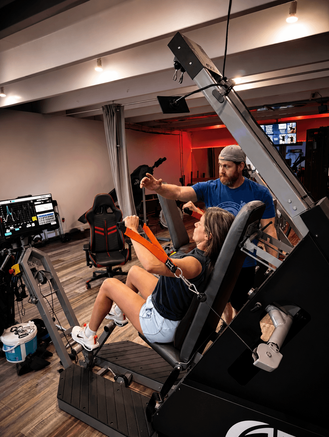 Athlete training on Elast-a-Dapt adaptive resistance machine with elastic band technology and live force-curve data display